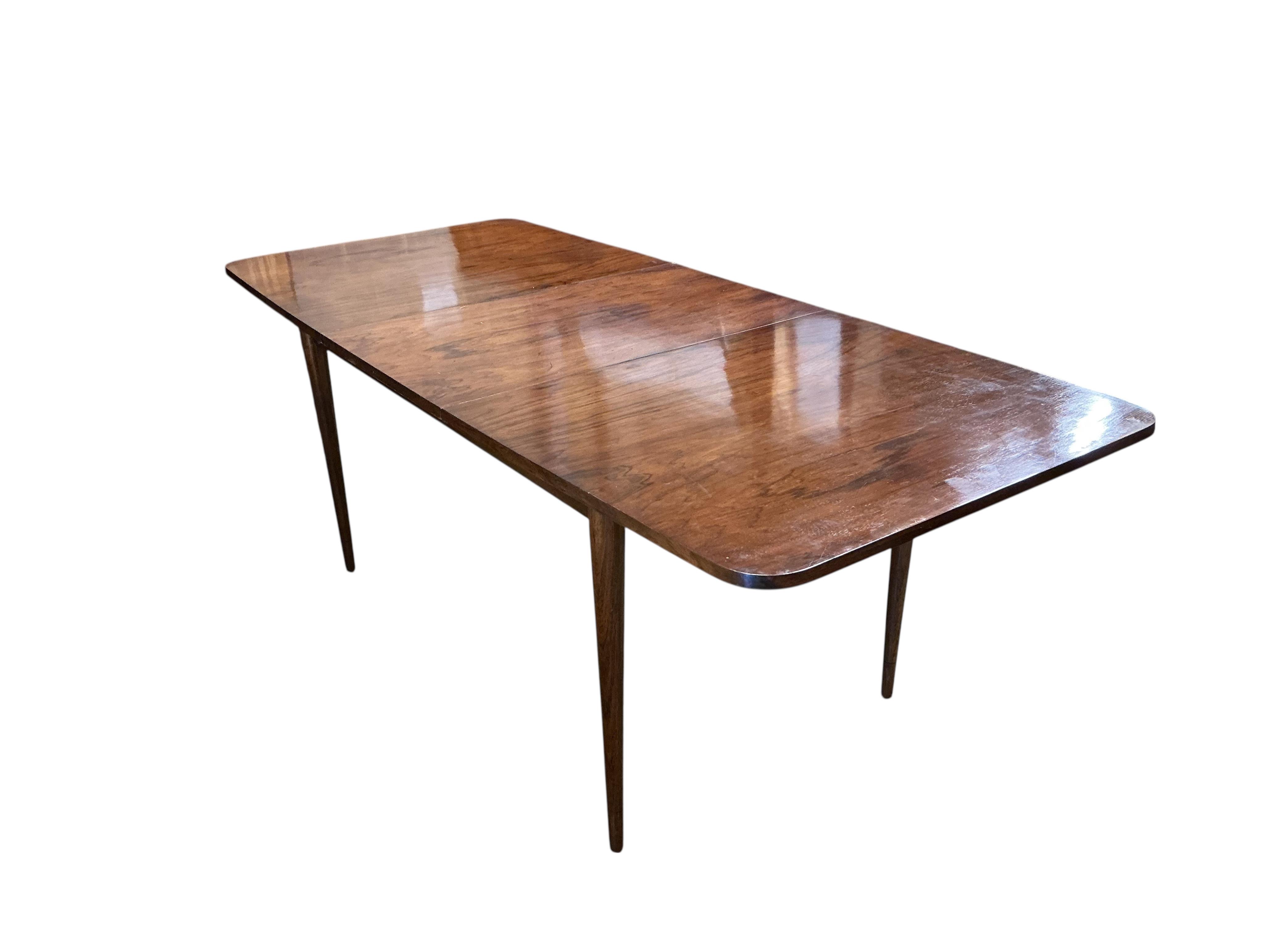 A mid century Archie Shine Indian rosewood extending dining table, width 144cm, depth 84cm, height 72cm and six upholstered chairs, two with arms